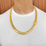 9k yellow gold Miami Cuban Chain 12 mm wide with a safety box clasp on a man to show the size. Heavy weight link.