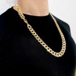 Flat Bevelled Curb Chains in 9k yellow gold, 12 mm wide with wide links. The chain is Italian made with fancy designed and a safety lobster clasp. This chain is fully UK hallmarked and sent out securely in a gift box.