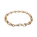 9k yellow gold solid tulip bracelet for men, women and kids. The bracelet is 7.5 mm wide with patterned links.
