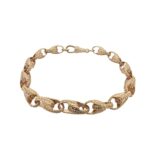 9k yellow gold solid tulip bracelet for men, women and kids. The bracelet is 7.5 mm wide with patterned links.