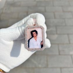 A picture rose gold pendant stone set with diamonds with a picture of a loved one placed inside.